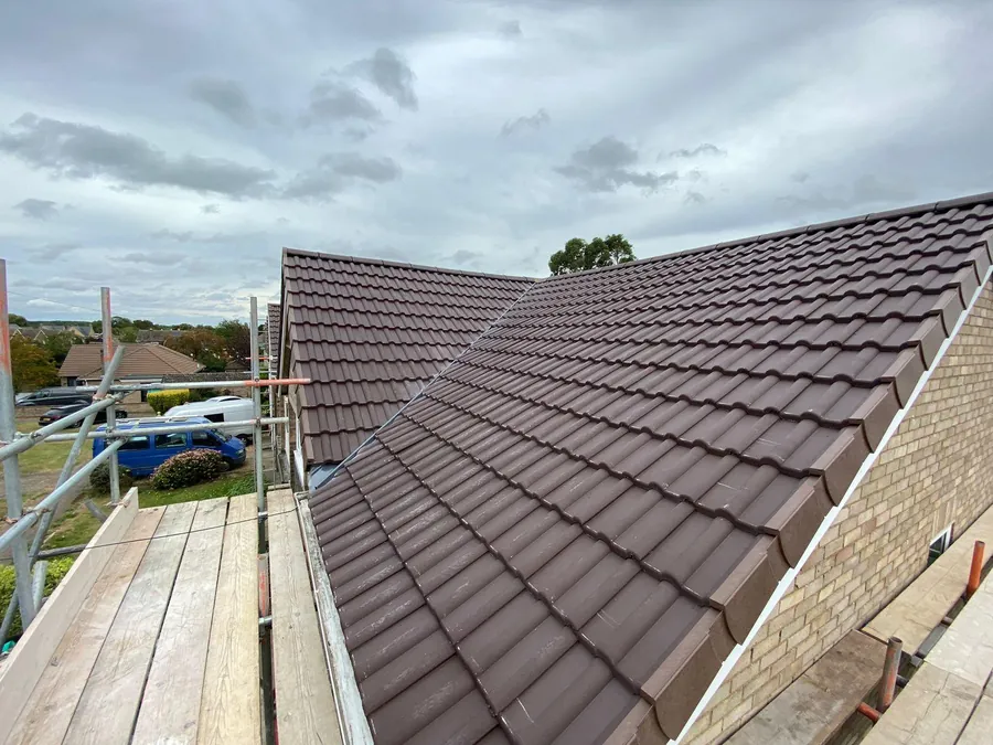 Brown concrete tiled roof finished from the scaffold, Imperial Roofcraft roofing job in London and Surrey