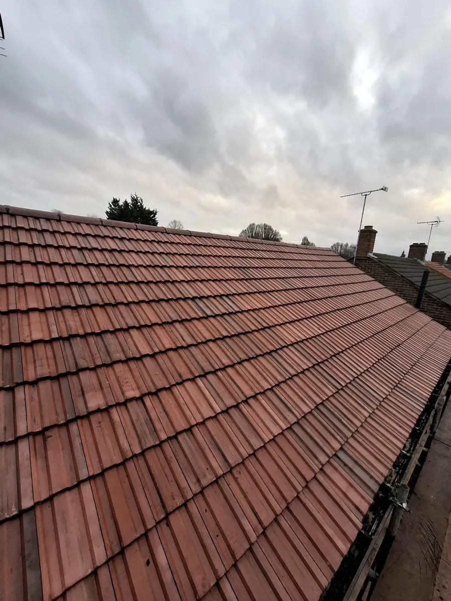 Finished brown tiled slope above the back gardens, Imperial Roofcraft roofing job in London and Surrey
