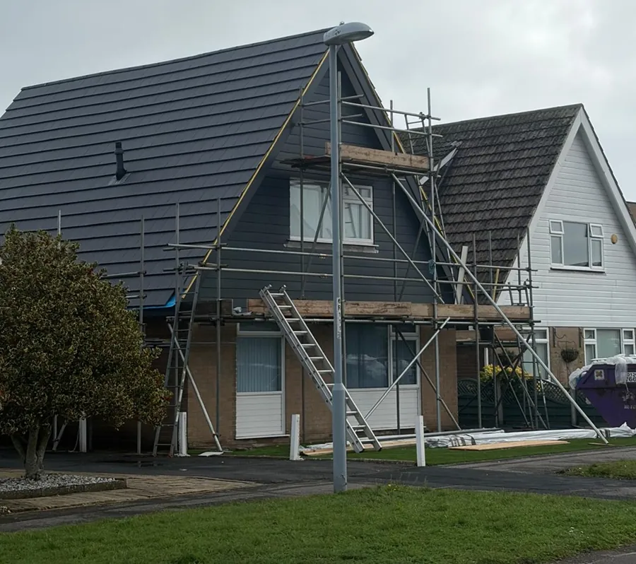 Scaffold up on a chalet bungalow during a grey tile re-roof, Imperial Roofcraft roofing job in London and Surrey
