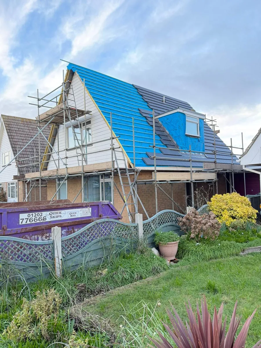 Scaffold and blue membrane on a chalet bungalow re-roof, Imperial Roofcraft roofing job in London and Surrey