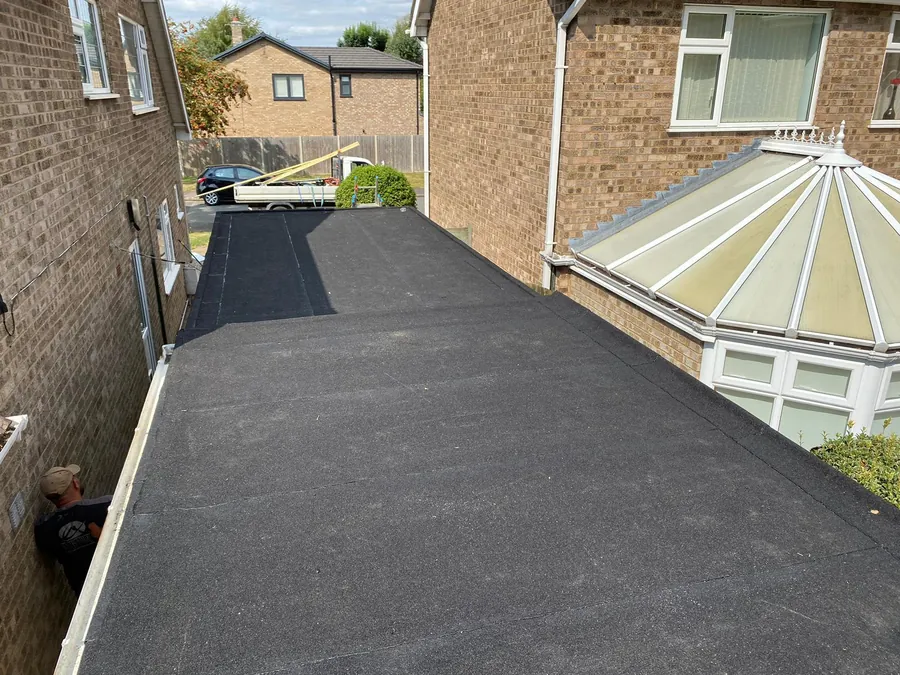 Felt flat roof finished beside a conservatory, Imperial Roofcraft roofing job in London and Surrey