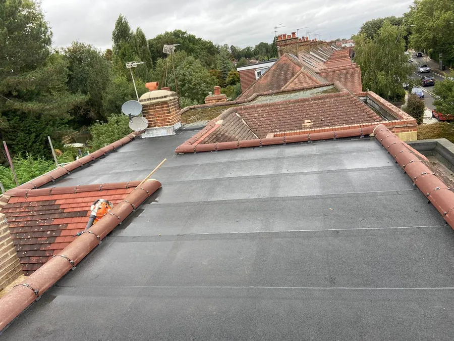 Completed flat roof between pitched clay tile slopes, Imperial Roofcraft roofing job in London