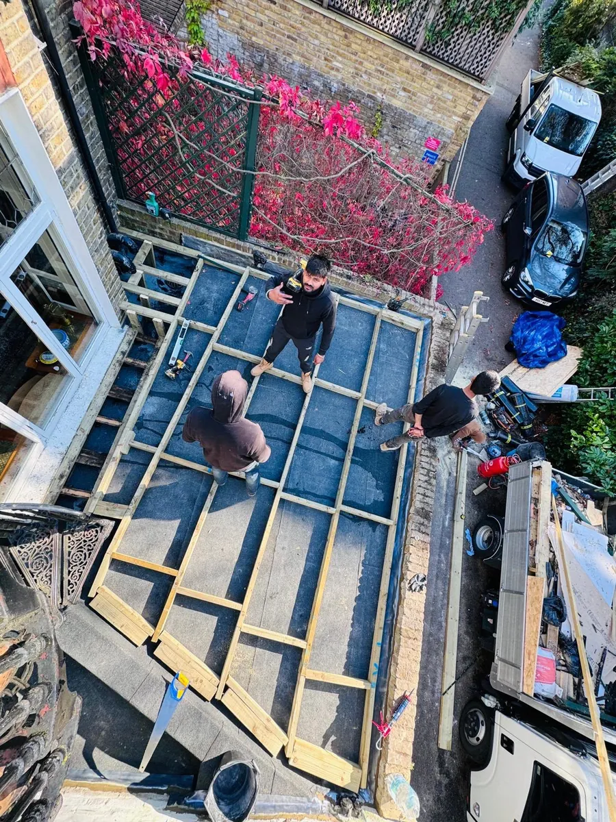Flat roof joists and firrings seen from above during a rebuild, Imperial Roofcraft roofing job in London