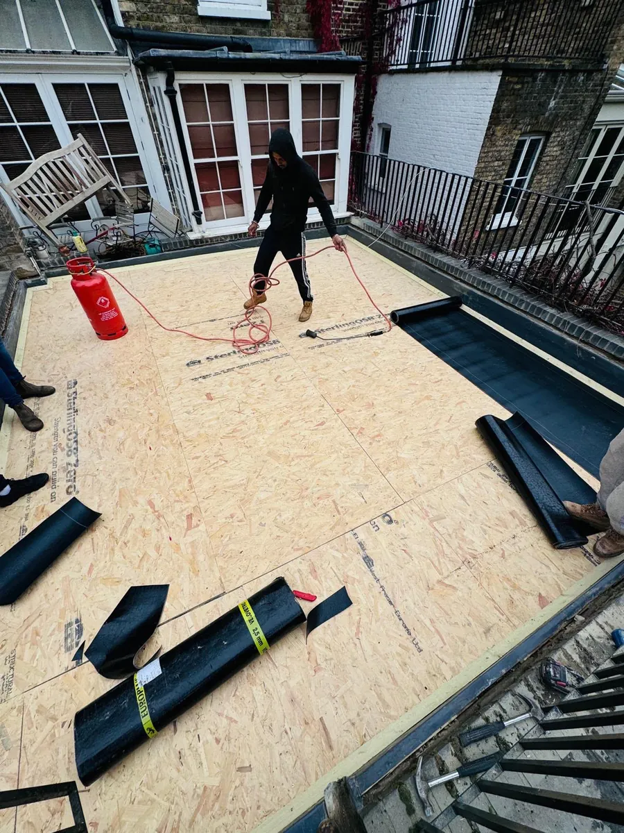 Plywood flat roof deck with membrane rolls ready to lay, Imperial Roofcraft roofing job in London