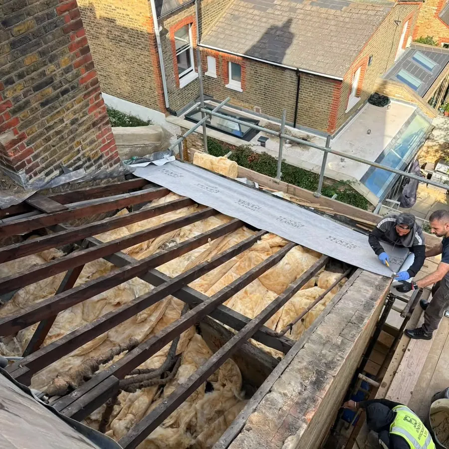 Flat roof stripped to the joists with insulation exposed, Imperial Roofcraft roofing job in London