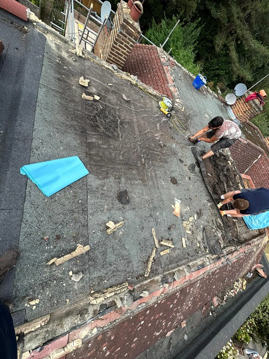 Old flat roof covering being stripped back by the team, Imperial Roofcraft roofing job in London