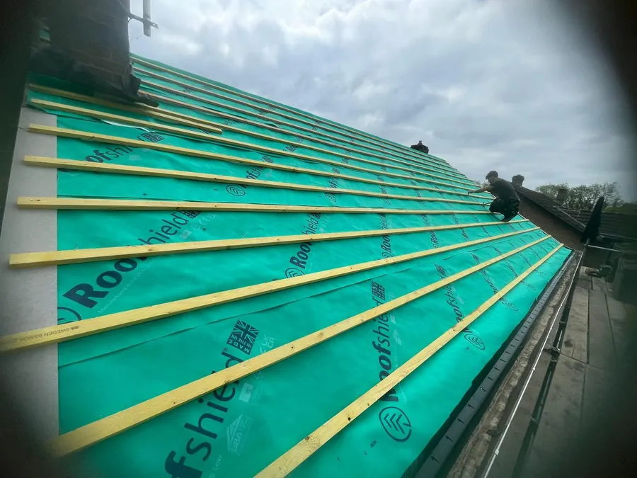 New battens over green membrane along a full roof slope, Imperial Roofcraft roofing job in London and Surrey