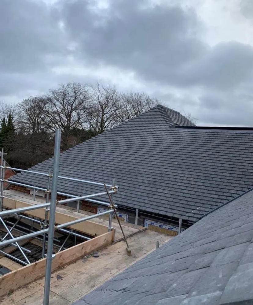Completed grey hip roof seen from the scaffold, Imperial Roofcraft roofing job in London