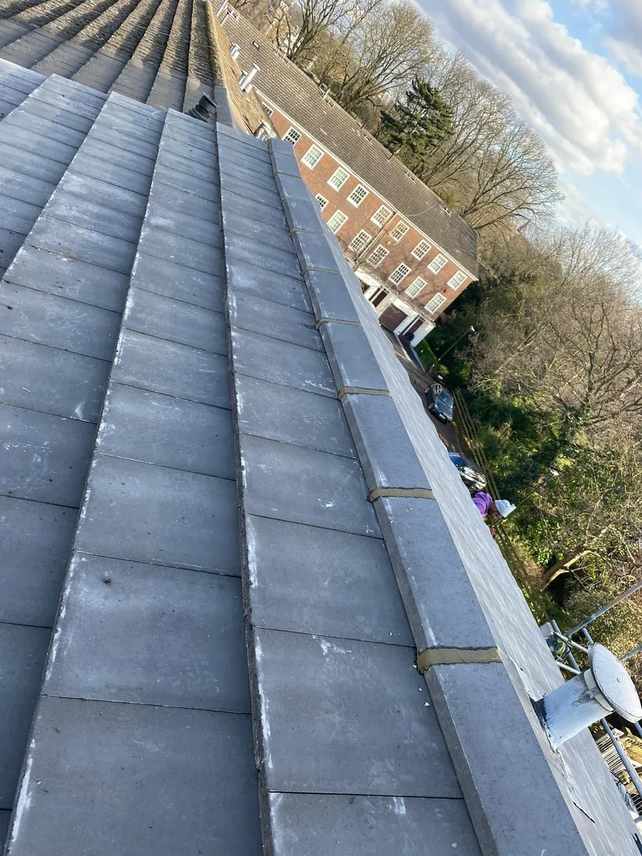 Grey tiles and ridge line on a terrace roof, Imperial Roofcraft roofing job in London