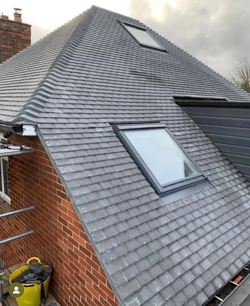 New grey tiled slope with a rooflight beside a brick chimney, Imperial Roofcraft roofing job in London