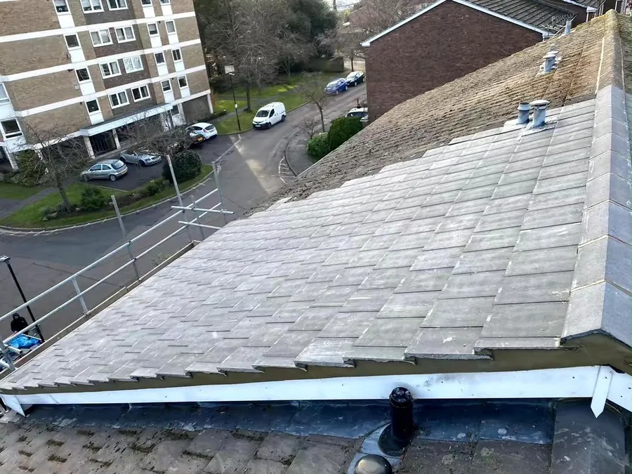 Grey tiled low pitch roof finished at the eaves above a flat roof, Imperial Roofcraft roofing job in London and Surrey