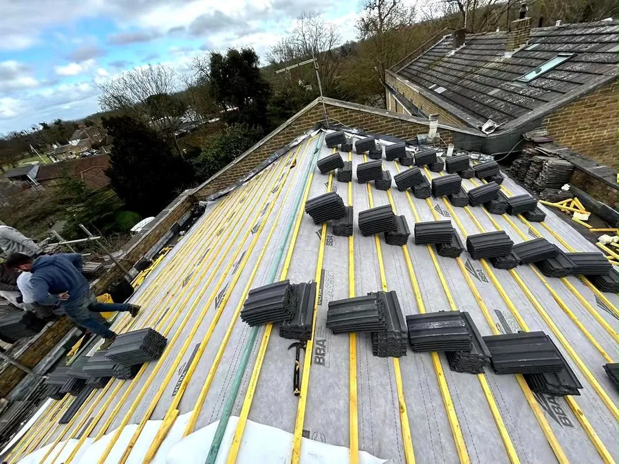 New breathable membrane and battens with tiles loaded out ready to lay, Imperial Roofcraft roofing job in London and Surrey
