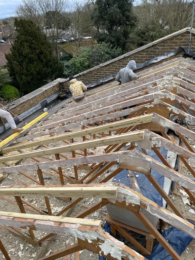 Team fitting new roof timbers over the old trusses, Imperial Roofcraft roofing job in London and Surrey