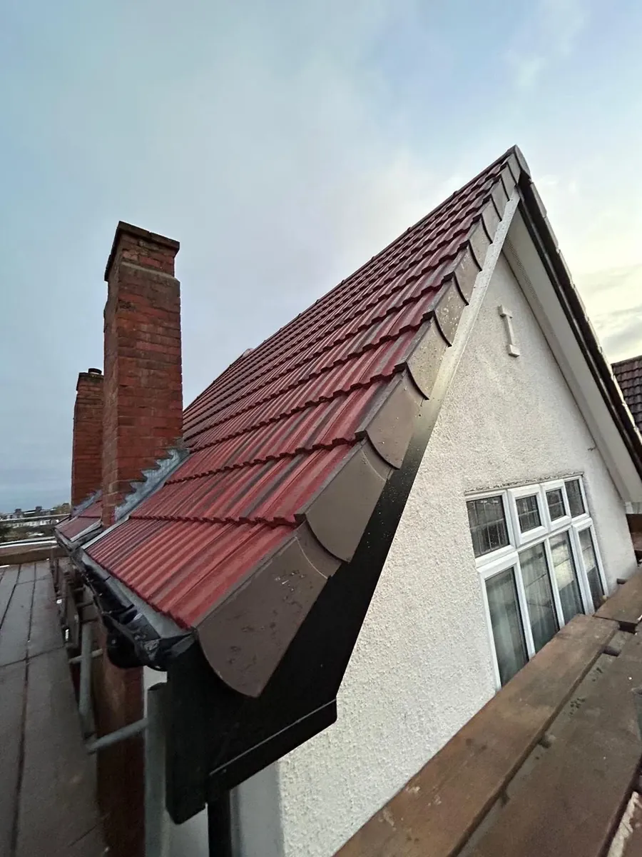 Red tiled roof finished with a dry verge on a rendered gable, Imperial Roofcraft roofing job in London and Surrey