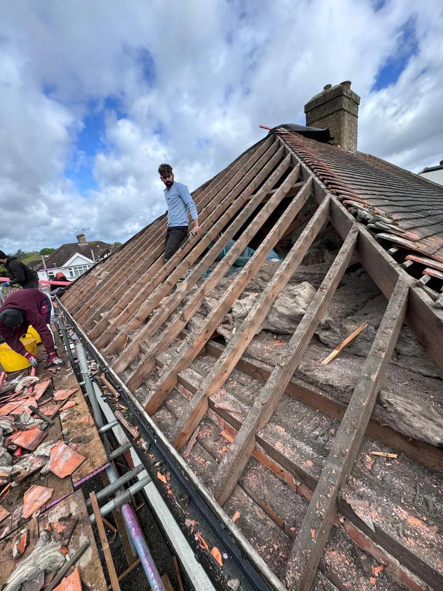 Old red tiles stripped back to the rafters by the team, Imperial Roofcraft roofing job in London and Surrey