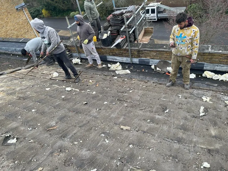Team lifting the old roof covering at the start of a re-roof, Imperial Roofcraft roofing job in London and Surrey