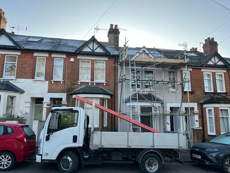Our truck and scaffold outside a terraced house on a roofing job, Imperial Roofcraft roofing job in London and Surrey