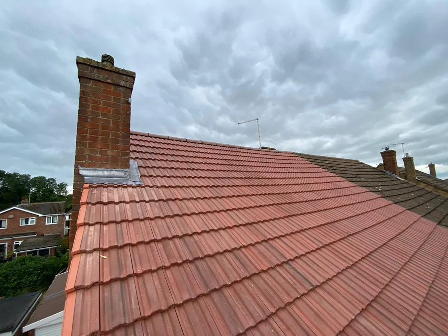 New red tiled roof with lead flashing at the chimney, Imperial Roofcraft roofing job in London and Surrey