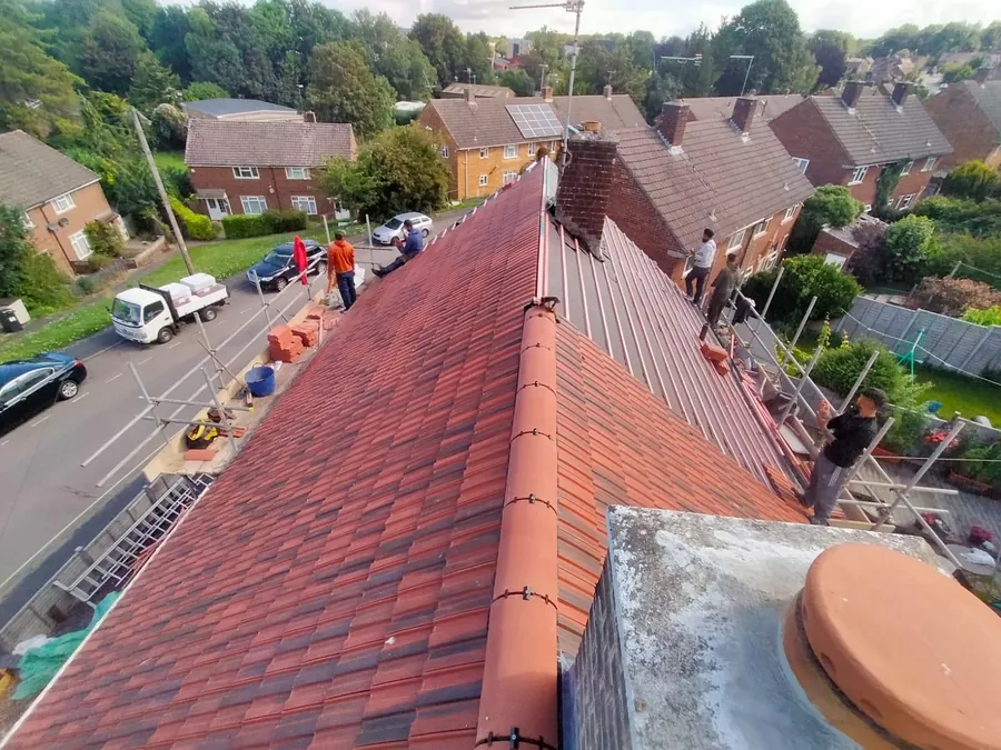 Imperial Roofcraft team on a red tile re-roof above the street, Imperial Roofcraft roofing job in London