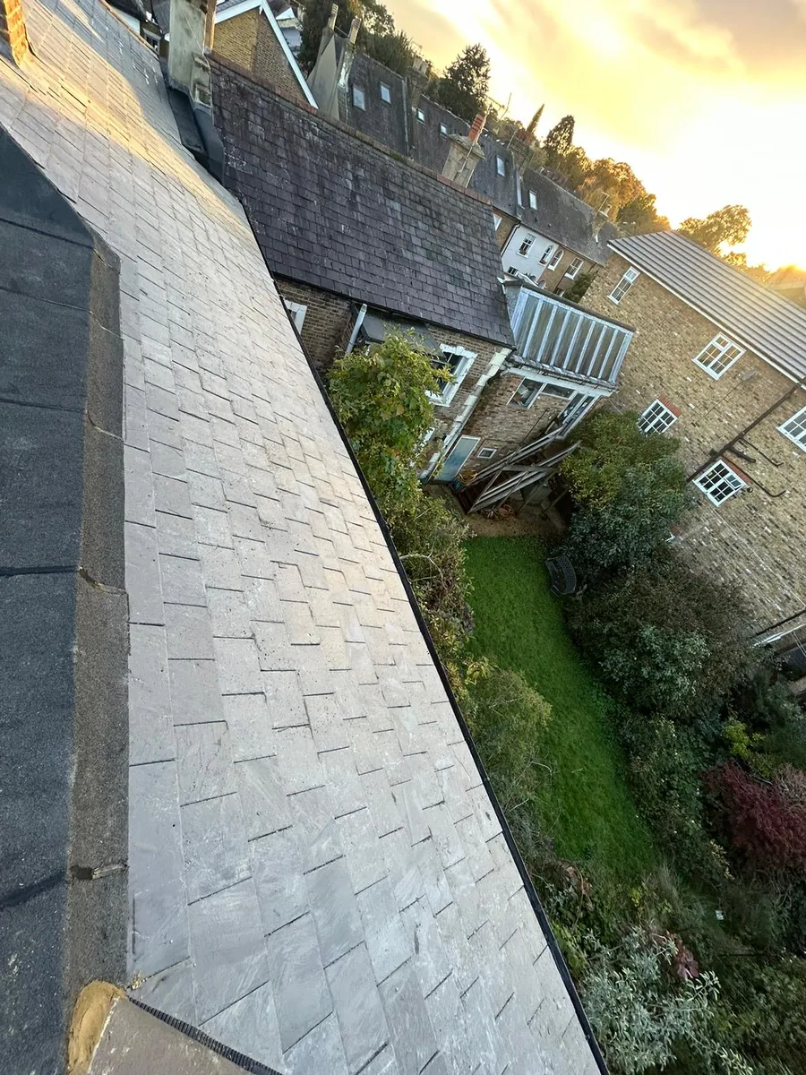 Slate-effect tiles finished at the verge of a terrace roof, Imperial Roofcraft roofing job in London