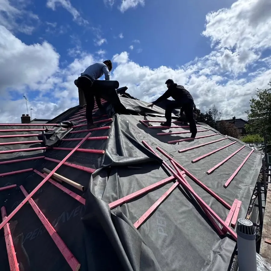 Two Imperial Roofcraft roofers working on a re-roof, Imperial Roofcraft roofing job in London