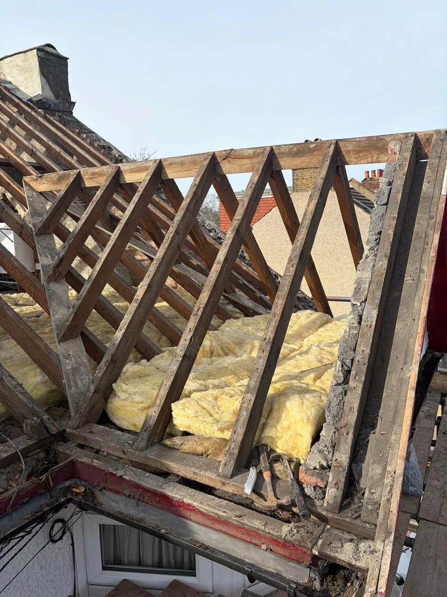 Roof stripped back to the trusses with the loft insulation exposed, Imperial Roofcraft roofing job in London and Surrey